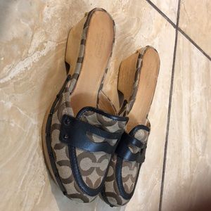 Tan and black Coach mules